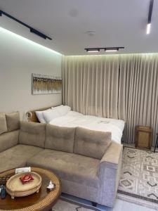 a living room with a couch and a bed at سندباد in Riyadh