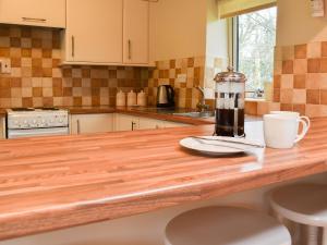 a kitchen with a counter with a coffee maker on it at The Farriers - 26967 in Windermere