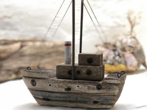 a model of a wooden boat on a table at Cider Press Cottage in Fowey