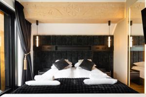 a bedroom with a large bed with white pillows at Góralski Resort 2 z Basenem in Białka Tatrzańska