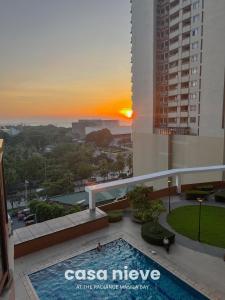 a view of the sunrise from the balcony of a building at Casa Nieve Manila Bay - Pet friendly in Sampong