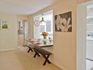 a dining room with a table and a bench at Midships in Instow