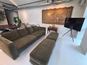 a living room with a couch and a flat screen tv at Milk barn in Cote