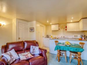 a living room with a couch and a table at Blossom Cottage in Goldsborough