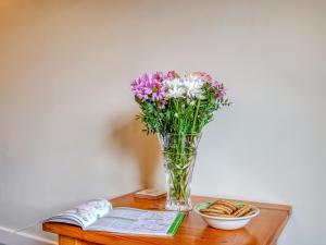 a vase of flowers sitting on a table at Blossom Cottage in Goldsborough +10 photos