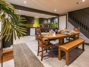 a kitchen and dining room with a wooden table and chairs at St Hildas Rest in Hinderwell