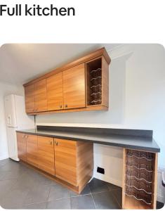 a kitchen with wooden cabinets and a counter top at Shekinah glory in Stockton-on-Tees
