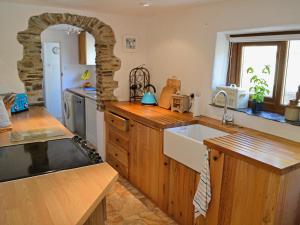 a kitchen with a sink and a counter top at Dover Row Cottage in Zelah