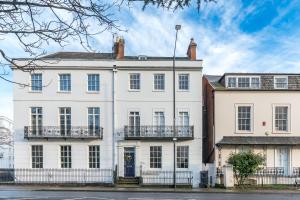 a large white house with a fence at Stunning Townhouse & Basement in Leamington Spa in Leamington Spa