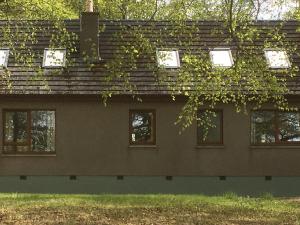 a building with a roof covered in ivy at Scobach Lodge in Turriff +6 photos