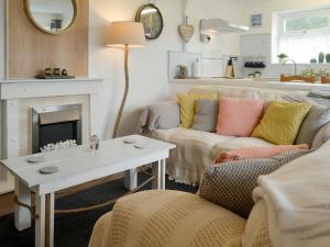 a living room with a couch and a fireplace at The Loft in Amlwch