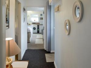 a room with a hallway with a clock on the wall at The Loft in Amlwch