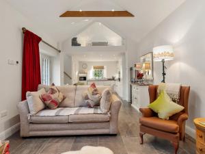 a living room with a couch and a chair at Cranford-Cottage in Saint Brides