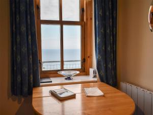 a table in front of a window with a view at St Abbs The Flag House in Saint Abbs
