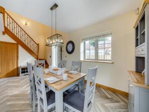 a kitchen and dining room with a table and chairs at Garth House - Castlesteads in Brampton