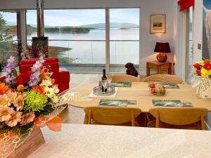 a room with tables and chairs and a large window at Tidereach - Otters View - Uk12269 in Connel