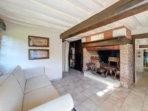 a living room with a couch and a fireplace at la chaumière de Vieux Port in Vieux-Port