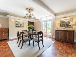 a dining room with a table and chairs and a chandelier at Pinley Hill House in Shrewley
