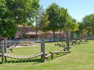 a group of picnic tables in a park at Belgian Cottage in Sewerby