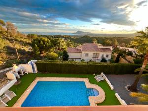 a villa with a swimming pool and a house at Large chalet with private pool in Altea