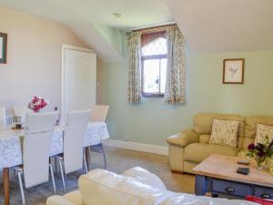 a living room with a couch and a table at Millstream - Uk45183 in Penton