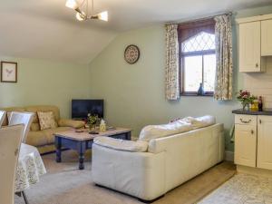 a living room with a couch and a table at Millstream - Uk45183 in Penton