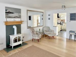 a living room with a fireplace and a table and chair at Sea Scape - Uk35432 in Whitstable