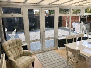 a room with glass doors and a table and chairs at Sea Scape - Uk35432 in Whitstable
