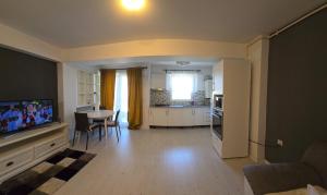 a living room with a kitchen and a dining room at Airport Residence in Otopeni