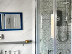 a bathroom with a shower and a mirror at The Captains in Bettyhill