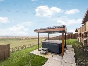 a picnic shelter in a field next to a fence at Coo Lodge - Uk48430 in Falkirk +29 photos