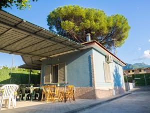 a patio with chairs and a table under awning at Il Paradiso Verde in Pagani