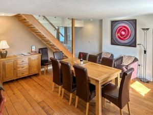 a dining room with a table and chairs at Dolgoed House in Llangadog