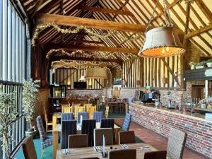 a dining room with tables and chairs in a building at Twin Oaks in Fritton Norfolk +21 photos
