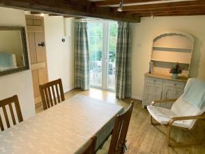 a kitchen with a table and chairs in a room at Hollywell Cottages in Clifton