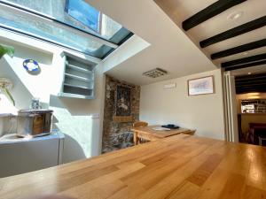 a dining room with a wooden table and a window at T'owd Man's Cottage in Bonsall