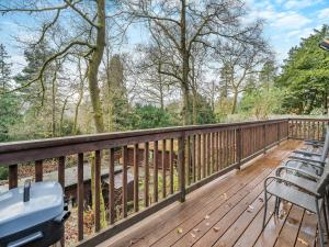 une terrasse en bois avec des chaises et des tables. dans l'établissement Seathwaite Tarn, à Ambleside