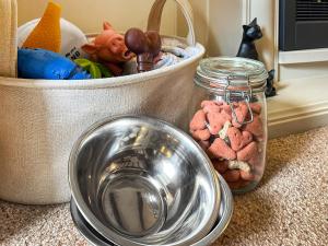 a bowl of food next to a container of dog food at Lavender Cottage in Shrewsbury