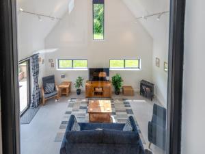 a living room with blue couches and a fireplace at Dunley Barn in Winterslow