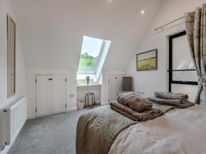 a bedroom with a bed with towels on it at Dunley Barn in Winterslow +17 photos