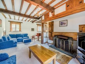 a living room with blue couches and a fireplace at High Biggin in Windermere