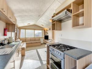 a kitchen with a stove top oven in a room at Vanhalla in Morecambe +26 photos