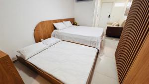 a room with two beds and a couch at Hoa Beach Flat 205 in Tamandaré
