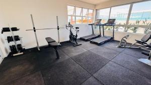 a gym with treadmills and elliptical machines at Hoa Beach Flat 205 in Tamandaré