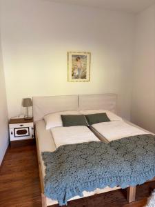 a bedroom with a large white bed and a table at Landhaus nähe Neusiedler See in Jois
