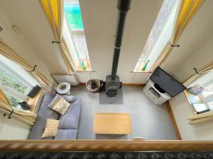 an overhead view of a living room with a couch and a tv at Coach House in Wareham