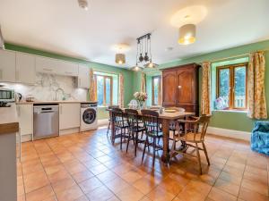 a kitchen with a table and chairs in it at St Mary's Chapel in New Buckenham
