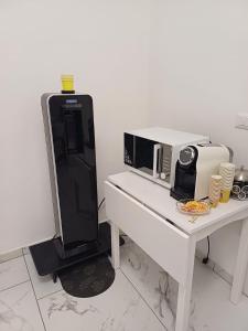 a microwave sitting on a white table next to a counter at Orchidea Stazione in Bologna