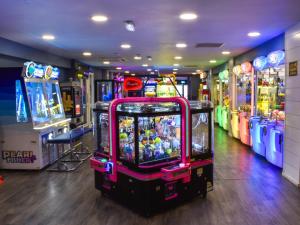 a video game arcade with several arcade machines in a room at The Moon in Heysham