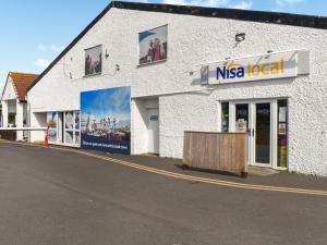 a nasa local store on the side of a street at The Moon in Heysham